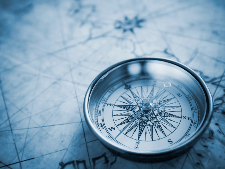 A compass rests on a map, symbolizing navigation and exploration for business opportunities.